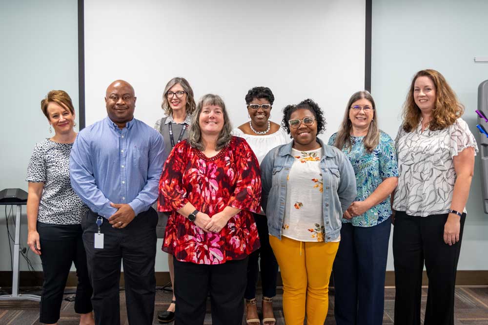 group of employees smiling 